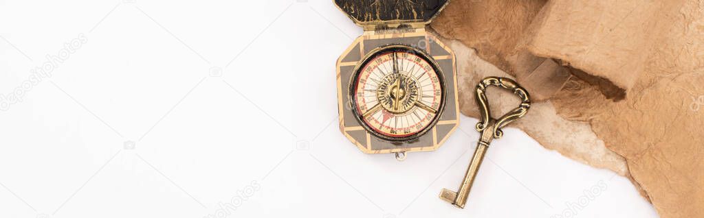 top view of vintage key, compass and aged paper isolated on white, panoramic shot