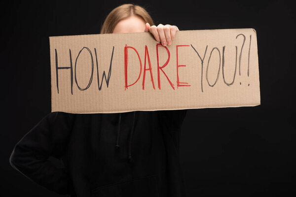 Cropped view of woman holding placard with how dare you lettering isolated on black, global warming concept