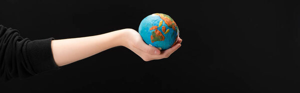 Panoramic view of woman with outstretched hand holding plasticine globe isolated on black, global warming concept