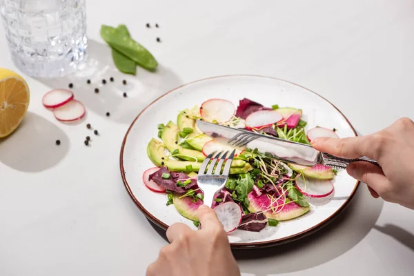 Cropped View Woman Eating Fresh Radish Salad Greens Avocado White — Stock Photo, Image