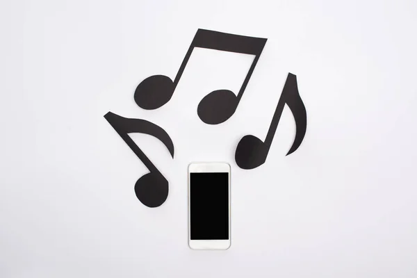 Vista Superior Notas Corte Papel Musical Teléfono Inteligente Sobre Fondo — Foto de Stock