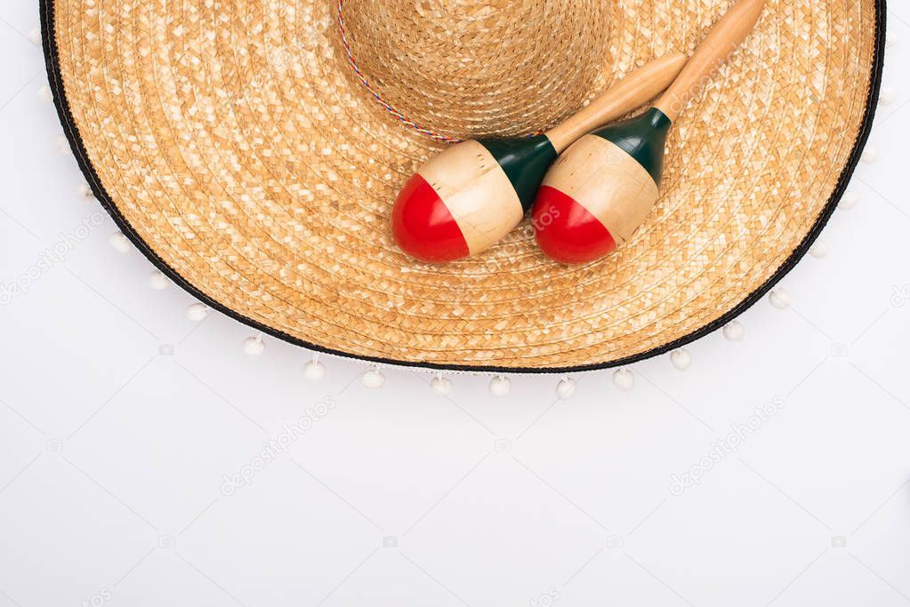 Top view of maracas with sombrero on white background