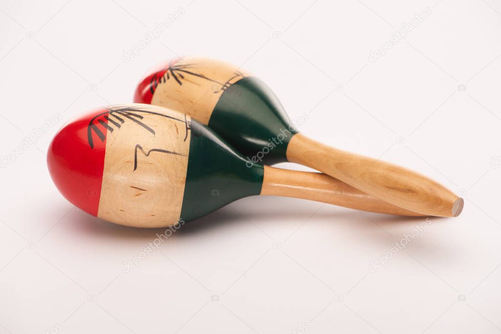 Close up view of colorful wooden maracas on white background