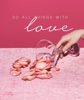 cropped view of woman with scattered petals from glass on velour cloth isolated on pink, do all thing with love illustration  clipart