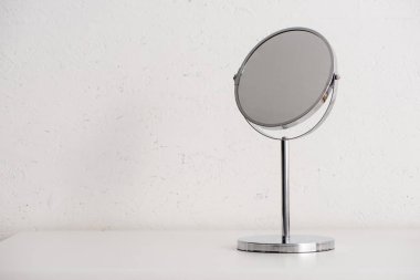 Round mirror on white background, zero waste concept clipart