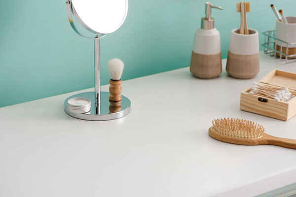 Various beauty and hygiene objects with round mirror in bathroom, zero waste concept