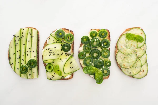 Flat Lay Fresh Cucumber Toasts Seeds Mint Basil Leaves White — Stock Photo, Image