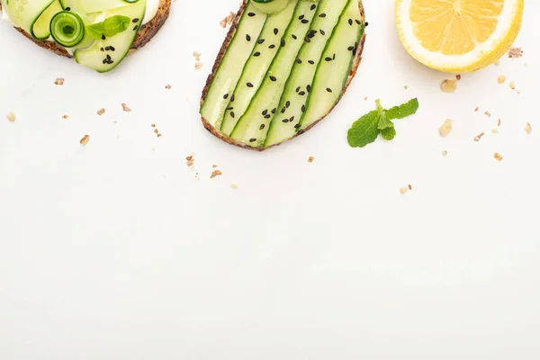 Top View Fresh Cucumber Toasts Seeds Mint Leaves Lemon White — Stock Photo, Image
