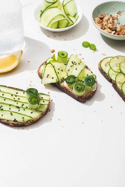 Fresh Cucumber Toasts Seeds Mint Leaves Lemon Glass Water White — Stock Photo, Image