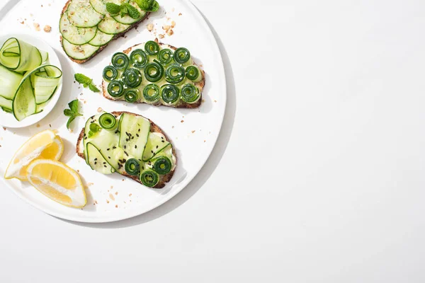 Top View Fresh Cucumber Toasts Seeds Mint Basil Leaves Plate — Stock Photo, Image