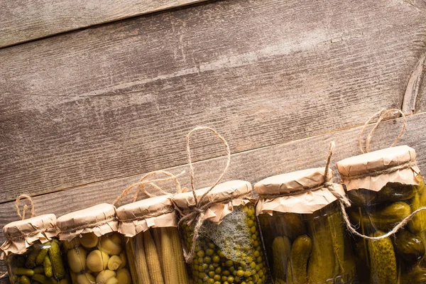 Top view of green tasty homemade pickles in jars on wooden rustic table — Stock Image Top View Green Tasty Homemade Pickles Jars Wooden Rustic Table Stock Picture