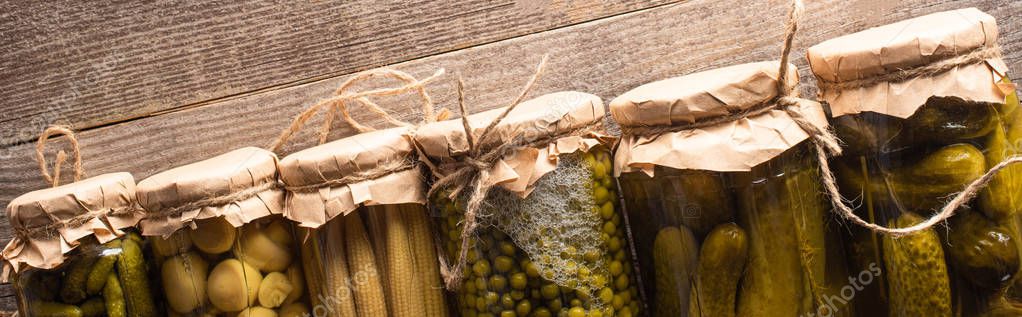 Top view of green tasty homemade pickles in jars on wooden rustic table, panoramic shot — Stock Image Top View Green Tasty Homemade Pickles Jars Wooden Rustic Table Stock Picture