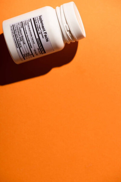 High angle view of white container on orange background
