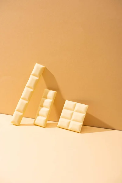 Сладкий Вкусный Сломанный Белый Шоколад Бежевом Фоне — стоковое фото