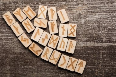 Top view of ethnic runes on wooden surface with copy space clipart
