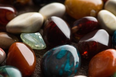 Close up view of ritual fortune telling stones on wooden background clipart