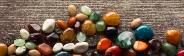 Top view of fortune telling stones on wooden surface, panoramic shot  clipart