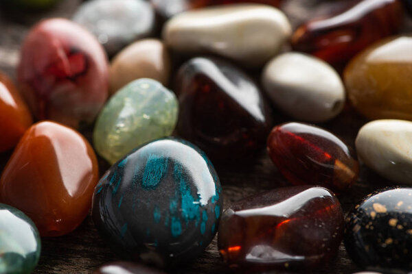 Close up view of colorful fortune telling stones on wooden background