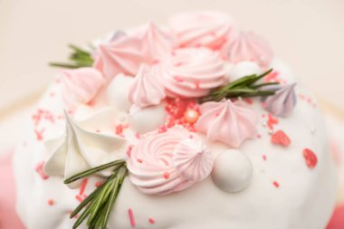 close up view of tasty Easter cake with rosemary and meringue on glaze clipart
