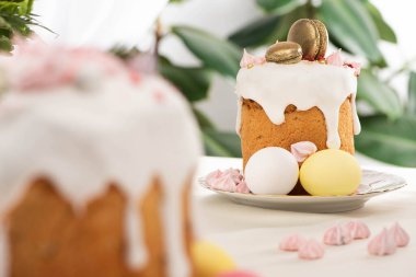 selective focus of Easter cakes with white glaze and meringue clipart