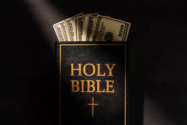 Top View Holy Bible Money Dark Background Sunlight — Stock Photo, Image