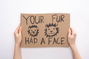 partial view of woman holding cardboard sign with your fur had a face inscription on white background clipart