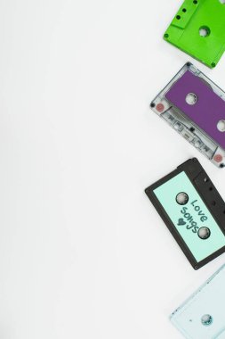 top view of green, purple and turquoise cassettes on white background clipart