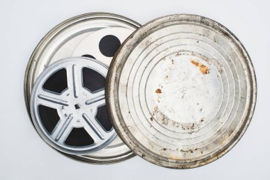 top view of film reels with tape in rusty tin case on white background clipart