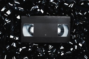 top view of black VHS cassette on film strip clipart
