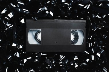 top view of black VHS cassette on film strip clipart