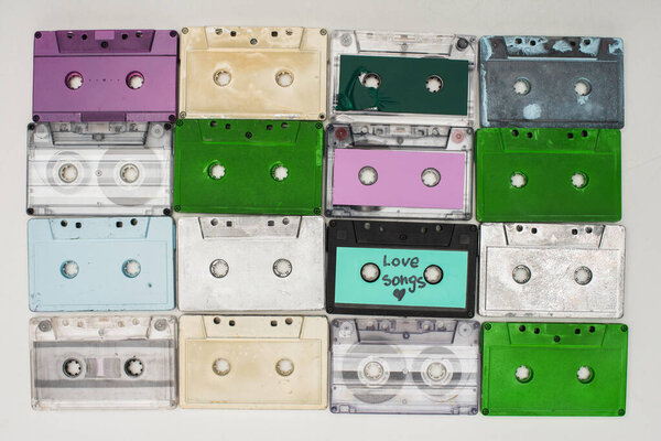 top view of colorful recording cassettes on white background