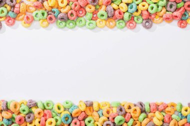 top view of bright multicolored breakfast cereal on white background clipart