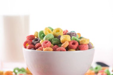 selective focus of bright multicolored breakfast cereal in bowl clipart