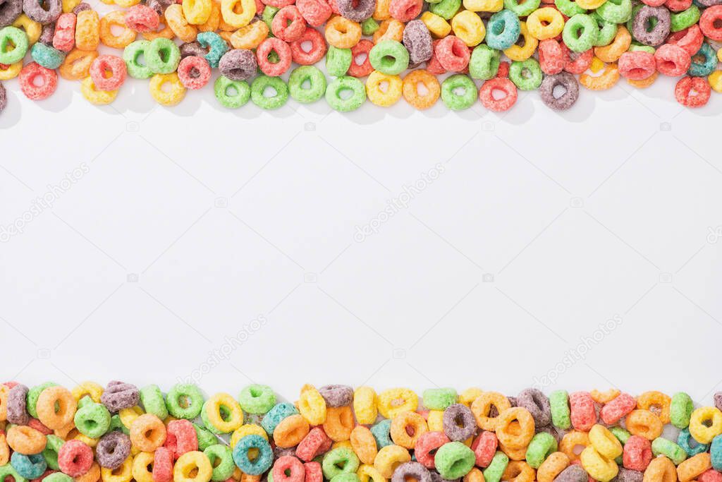 top view of bright multicolored breakfast cereal on white background