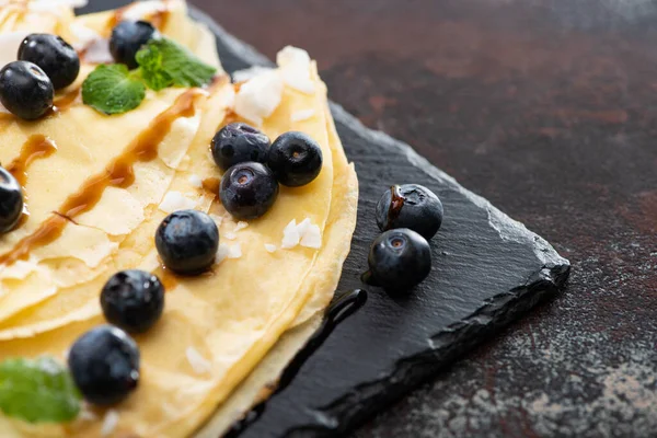 Close View Tasty Crepes Blueberries Mint Coconut Flakes Served Board — Stock Photo, Image
