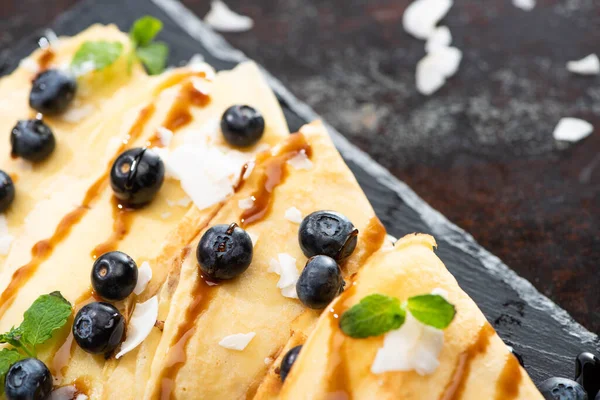 Close View Tasty Crepes Blueberries Mint Coconut Flakes Served Board — Stock Photo, Image