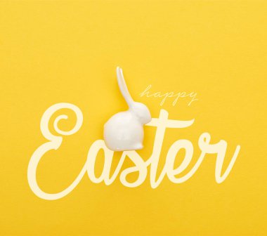 top view of white Easter bunny on colorful yellow background with happy Easter illustration clipart