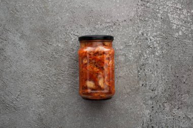 top view of kimchi in jar on grey concrete background clipart
