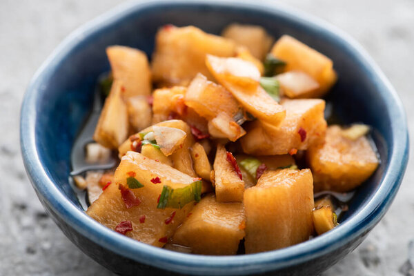 close up of tasty daikon radish kimchi in bowl