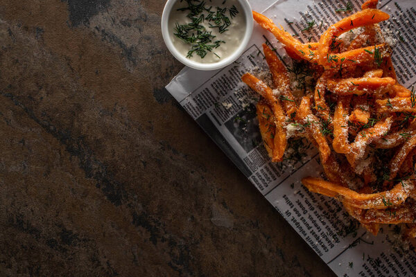 вид сверху на соленую картошку фри и кремовый чесночный соус на мраморной поверхности
 