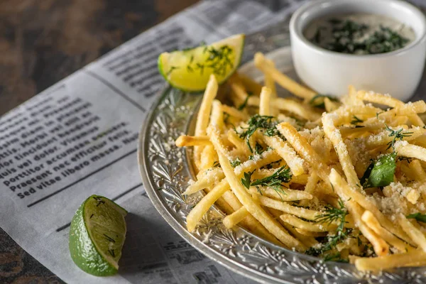 Selective Focus Salted French Fries Garlic Sauce Sliced Lime Newspaper — Stock Photo, Image