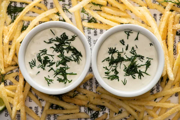 Top view of garlic sauce near crispy french fries with dill — Stock Image Top View Garlic Sauce Crispy French Fries Dill Stock Picture