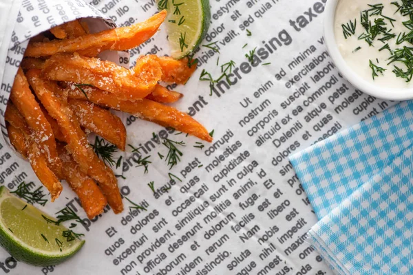 Top view of crispy french fries, sliced lime, cotton napkin and garlic sauce on newspaper — Stock Image Top View Crispy French Fries Sliced Lime Cotton Napkin Garlic Stock Photo