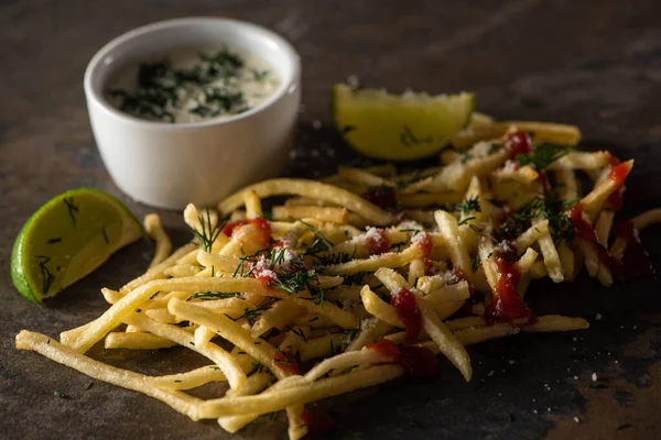 Selective focus of tasty french fries with ketchup, salt and dill near lime and garlic sauce on marble surface — Stock Image Selective Focus Tasty French Fries Ketchup Salt Dill Lime Garlic Stock Image