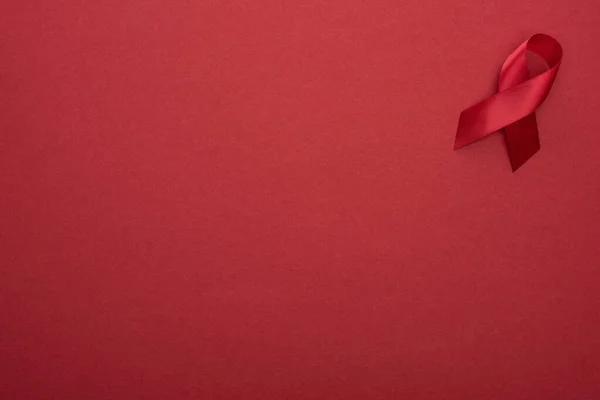 Kırmızı Farkındalığın Üst Görünümü Kırmızı Arkaplanda Kurdeleye Yardımcı Olur — Stok fotoğraf