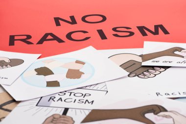black no racism lettering among pictures with multiethnic hands on red background clipart