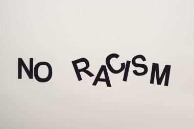 top view of black no racism lettering isolated on white clipart