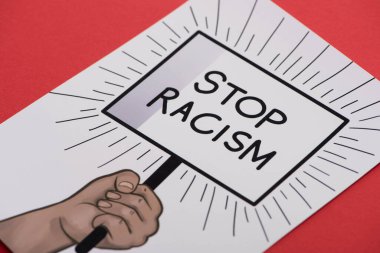 picture with drawn hand and stop racism placard on red background clipart