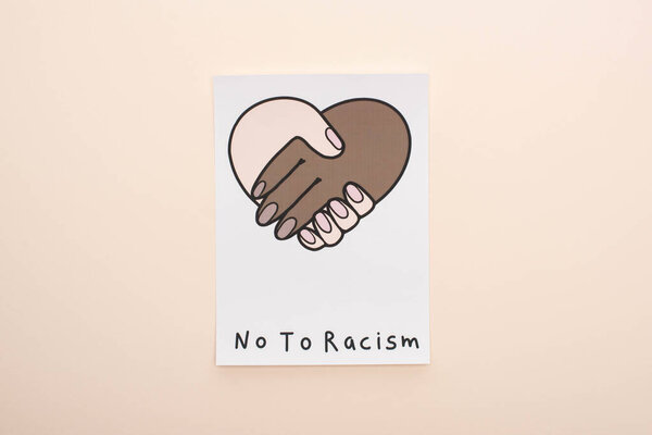 top view of picture with multiethnic handshake and no to racism lettering on beige background