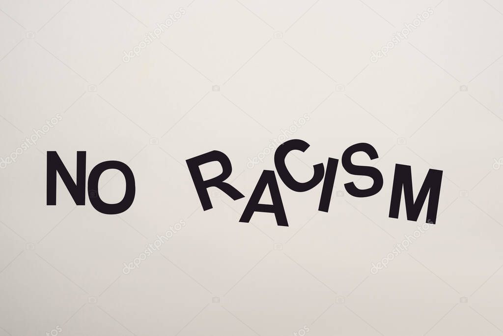 top view of black no racism lettering isolated on white